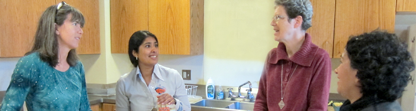 Sisters and sojourners share conversation over breakfast preparations