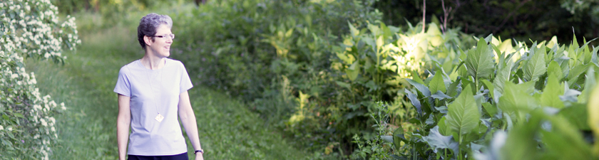 Sister Lynne walking along prairie path in early morning